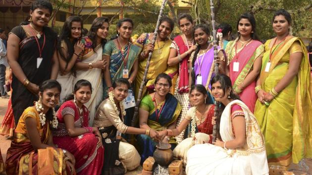 Students of Sri Kanyakaparameswari College cook during Pongal celebrations. (V Srinivasulu / HT photo)