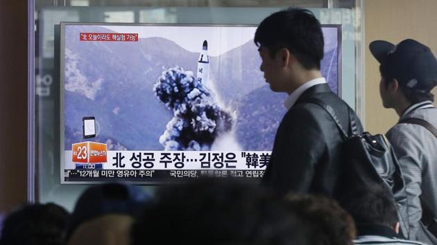 A man walks by as people watch a TV news program showing an image North Korea’s ballistic missile that the North claimed to have launched from underwater, at Seoul Railway station in South Korea. (AP File Photo) A man walks by as people watch a TV news program showing an image North Korea’s ballistic missile that the North claimed to have launched from underwater, at Seoul Railway station in South Korea. (AP File Photo)