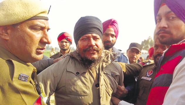 Gurbachan Singh, a relative of Sikh radical leader Amrik Singh Ajnala, in police custody after he hurled a shoe at Punjab CM Parkash Singh Badal at Ratta Khera village in Lambi segment.(Sanjeev Kumar/HT Photo)