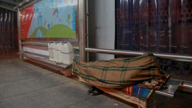 BENCHMARK: A bench at the ITO bus stop turns into a makeshift bed at night. (AMAL KS/HT PHOTO) 