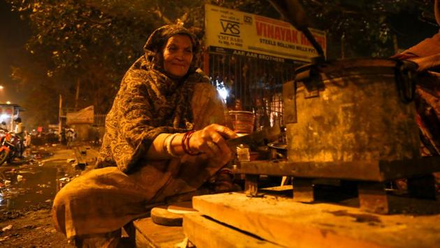 SMALL MERCIES: A woman cooks food at Motia Khan. (AMAL KS/HT PHOTO) 
