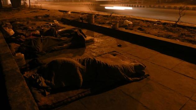 UNDER THE BRIDGE: A family that lives on the footpath under the flyover in Vasant Vihar. (AMAL KS/HT PHOTO) 