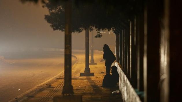 BRAVING THE CHILL: There are some who shiver all night under the open sky at Kashmere Gate, Outer Ring Road. (AMAL KS/HT PHOTO) 