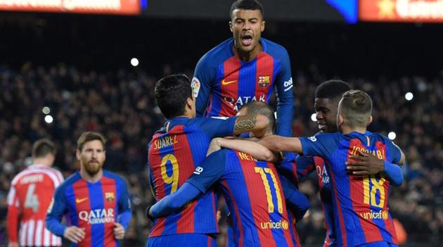 FC Barcelona players celebrate a goal during the Spanish Copa del Rey (King's Cup) round of 16 second leg football match against Athletic Bilbao at the Camp Nou stadium on Wednesday. Lionel Messi (left) scored a free-kick once again to secure Barca’s place in the quarter-finals.(AFP)
