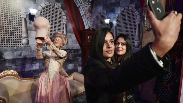 Visitors take selfies with the wax statue of Marie Tussaud, founder of Madame Tussauds wax museum displayed during an event at the Shangri la Hotel in New Delhi on January 12. Merlin Entertainments will open its first Madame Tussauds attraction in Delhi in June with 50 figures. 60% of the figures will be local celebrities and the rest, global. (Raj K Raj/HT PHOTO)