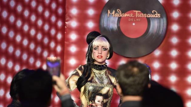 Visitors take photos of pop singer Lady Gaga’s wax statue displayed at the Shangri la Hotel in New Delhi. The museum will be housed in the Regal Cinema building at Connaught Place and will be spread over two floors. (Raj K Raj/HT PHOTO)