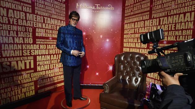 Visitors take pictures of actor Amitabh Bachchan’s wax statue. (Raj K Raj/HT PHOTO)