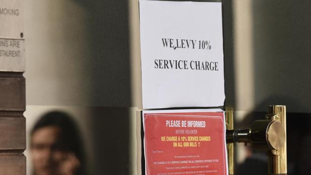 A restaurant in Connaught Place displaying a sign that service charges will be levied on the bill.(Sonu Mehta/HT PHOTO)