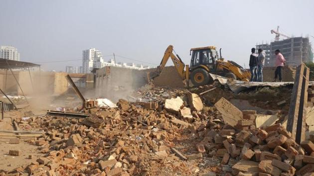 Over 400 unauthorised structures, including shops, labour hutments, food joints and building material shops, were razed on Thursday. (HT Photo) Over 400 unauthorised structures, including shops, labour hutments, food joints and building material shops, were razed on Thursday. (HT Photo)