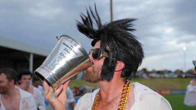 An amateur rugby player dressed as Elvis Presley drinks from the Memphis Mug trophy after the match between the Blue Suede Shoes and the Reddy Teddies at the 25th annual Parkes Elvis Festival. (REUTERS) An amateur rugby player dressed as Elvis Presley drinks from the Memphis Mug trophy after the match between the Blue Suede Shoes and the Reddy Teddies at the 25th annual Parkes Elvis Festival. (REUTERS)