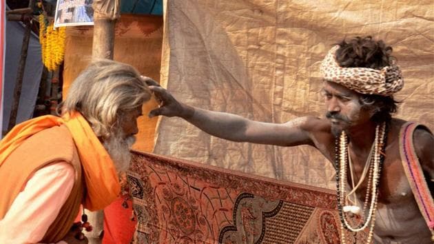 A Naga sadhu gives blessing to a sadhu at Gangasagar transit camp Babughat in Kolkata on Wednessday enroute to Gangasagar mela. (PTI Photo) 