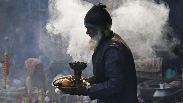A man begs for alms at a transit camp on the way to Gangasagar, in Kolkata. (Bikas Das / AP Photo) 