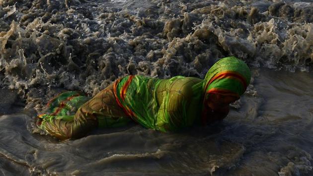 Devotees take holy bath and perform rituals in the Bay of Bengal at the mouth of the river Ganges in Sagar Island. (Dibyangshu Sarkar / AFP Photo) 
