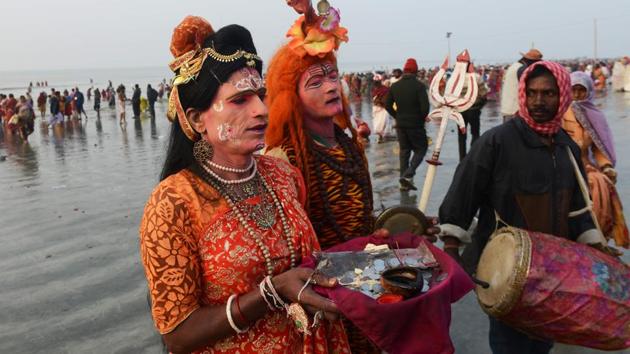 Devotees dressed as Hindu deities collect money from pilgrims at the mouth of the river Ganges on Gangasagar Island. (Dibyangshu SARKAR / AFP Photo) 