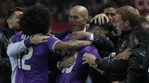 Real Madrid C.F. coach Zindeine Zidane celebrates Marco Asensio’s goal with players during the Copa del Rey (King’s Cup) match against Sevilla at the Ramon Sanchez Pizjuan Stadium on Thursday. Real won to set a Spanish record of 40 matches unbeaten. (AP) Real Madrid C.F. coach Zindeine Zidane celebrates Marco Asensio’s goal with players during the Copa del Rey (King’s Cup) match against Sevilla at the Ramon Sanchez Pizjuan Stadium on Thursday. Real won to set a Spanish record of 40 matches unbeaten. (AP)