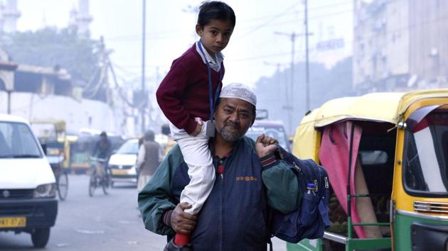 A man carries his son to school on a cold winter morning in old Delhi on Thursday, Jan 12, 2017. The Kejriwal government has extended the winter break for primary classes from Jan 16-19 in view of the prevailing cold conditions.(Arun Sharma/HT Photo) A man carries his son to school on a cold winter morning in old Delhi on Thursday, Jan 12, 2017. The Kejriwal government has extended the winter break for primary classes from Jan 16-19 in view of the prevailing cold conditions.(Arun Sharma/HT Photo)