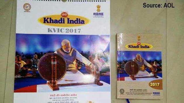 The PM’s photograph -- which was published on the cover pages of the Khadi Village Industries Commission’s (KVIC) 2017 calendar and diary -- shows Modi weaving khadi on a large ‘charkha’, in the same classic pose as Gandhi. (Twitter Photo) The PM’s photograph -- which was published on the cover pages of the Khadi Village Industries Commission’s (KVIC) 2017 calendar and diary -- shows Modi weaving khadi on a large ‘charkha’, in the same classic pose as Gandhi. (Twitter Photo)