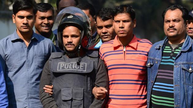Bangladesh police escort alleged Islamist militant Jahangir Alam (C) in Dhaka on January 14, 2017, after his arrest in connection with an attack on the Holey Artisan Bakery attack last year where 22 hostages were killed. (AFP Photo) Bangladesh police escort alleged Islamist militant Jahangir Alam (C) in Dhaka on January 14, 2017, after his arrest in connection with an attack on the Holey Artisan Bakery attack last year where 22 hostages were killed. (AFP Photo)