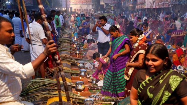 Devotees prepare pongal to offer to the Hindu Sun God as they attend Pongal celebrations early morning in Mumbai. (REUTERS)