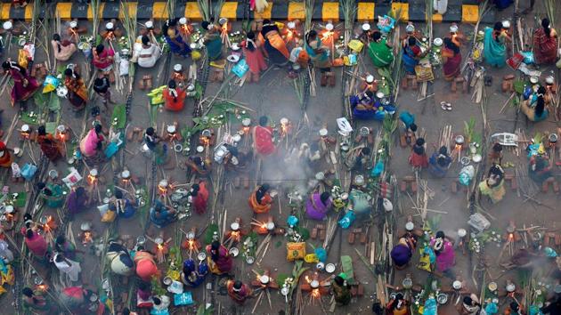 Devotees prepare rice dishes to offer to the Hindu Sun God as they attend Pongal celebrations early morning in Mumbai. (REUTERS)