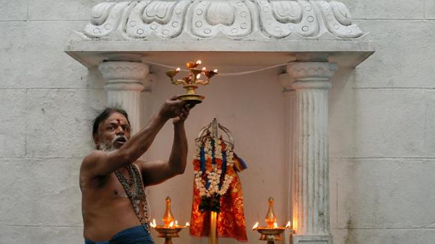 A Hindu priest prays during the Tamil harvest festival of Thai Pongal at a Hindu temple in Colombo. (REUTERS)