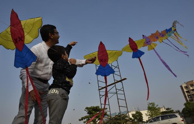 Jash and his father fly kites to celebrate Makar Sankranti near Bhakti Park in Mumbai. (Arijit Sen/HT PHOTO)