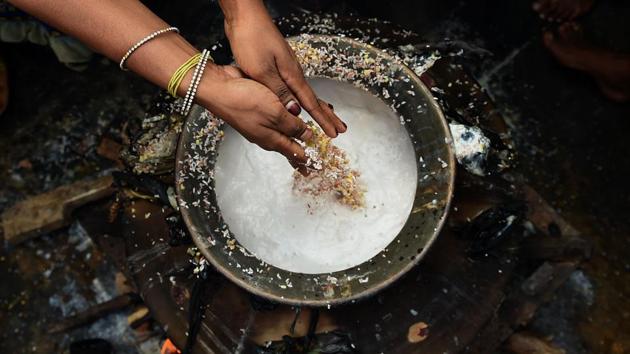 Sri Lankan Hindu devotees cook a ritual pongal dish, rice cooked with several other pulses, at a Hindu Temple in Colombo on Saturday. (AFP)