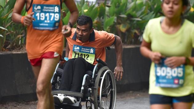 An athlete on wheel-chair participates in Mumbai Marathon. (Arijit Sen/HT PHOTO) 