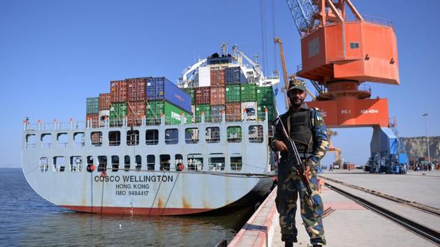 Pakistani Naval personnel stand guard near a ship carrying containers at the Gwadar port, some 700 kms west of Karachi.(AFP File Photo)
