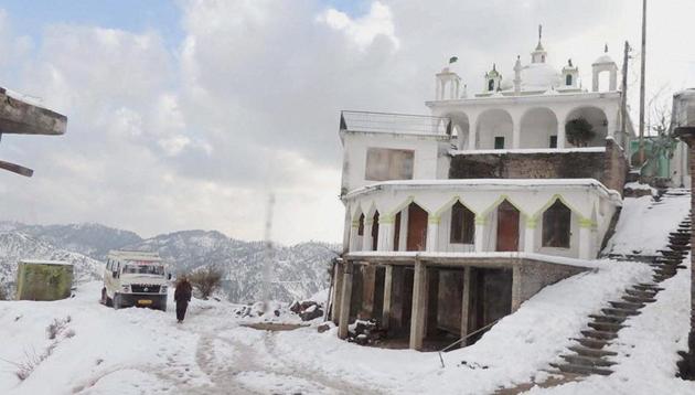 Vehicles passing through snow-covered roads near Kandi Area in Budhal district of J-K's Rajouri on Sunday. (PTI) Vehicles passing through snow-covered roads near Kandi Area in Budhal district of J-K's Rajouri on Sunday. (PTI)