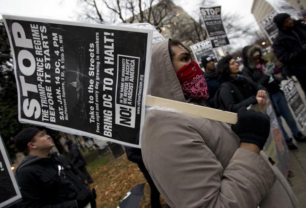 Demonstrators hold banners as they protest against president-elect Donald Trump in Washington on Saturday. (AP) Demonstrators hold banners as they protest against president-elect Donald Trump in Washington on Saturday. (AP)