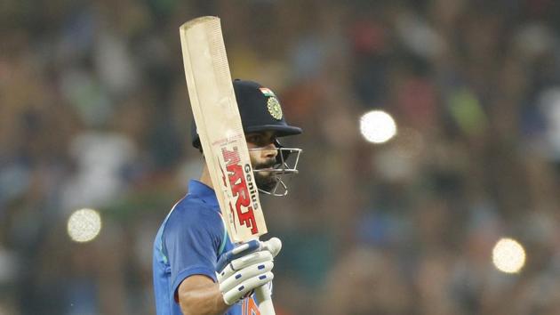 India national cricket team captain Virat Kohli celebrates his century in the first ODI against England in Pune on Sunday. He surpassed Sachin Tendulkar’s record of 14 centuries in successful chases.(AP)