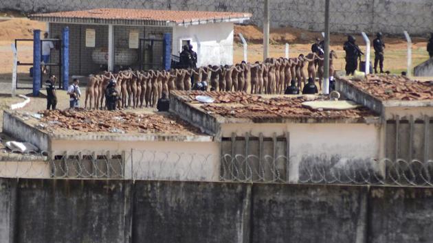 Naked inmates stand in line while surrounded by police after a riot at the Alcacuz prison in Nisia Floresta, Rio Grande do Norte state, Brazil, Sunday, Jan. 15, 2017. (AP Photo) Naked inmates stand in line while surrounded by police after a riot at the Alcacuz prison in Nisia Floresta, Rio Grande do Norte state, Brazil, Sunday, Jan. 15, 2017. (AP Photo)