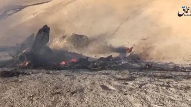 A still image taken on July 14, 2016 from a video posted on social media said to be shot today, July 14, 2016, shows the wreckage of a Syrian jet that was brought down by Islamic State fighters near the eastern city of Deir al-Zor, Syria. (Social Media) A still image taken on July 14, 2016 from a video posted on social media said to be shot today, July 14, 2016, shows the wreckage of a Syrian jet that was brought down by Islamic State fighters near the eastern city of Deir al-Zor, Syria. (Social Media)
