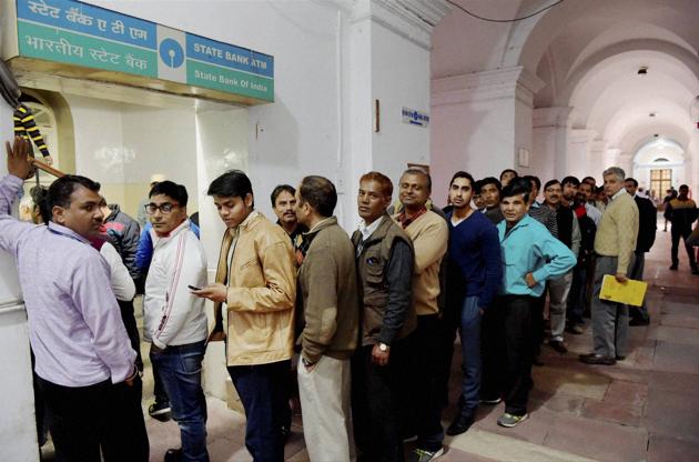 Employees of the finance ministry stand in a queue to withdraw cash from an ATM at North Block in New Delhi. (PTI) Employees of the finance ministry stand in a queue to withdraw cash from an ATM at North Block in New Delhi. (PTI)