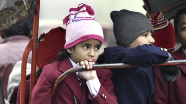 Schoolchildren travel to school in a cycle rickshaw on a cold winter morning in old Delhi. (Arun Sharma/HT PHOTO)
