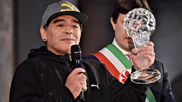 Diego Maradona holds the Italian football hall of Fame Award during a ceremony in Florence on Tuesday. (AP)