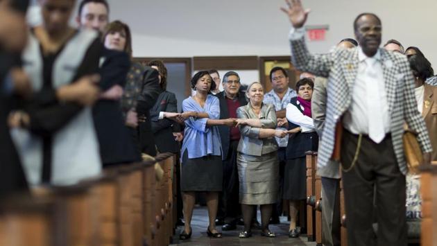 Audience members join hands while singing "We Shall Overcome" during a Martin Luther King Jr. holiday commemorative service at Ebenezer Baptist Church. (Branden Camp/AP) Audience members join hands while singing "We Shall Overcome" during a Martin Luther King Jr. holiday commemorative service at Ebenezer Baptist Church. (Branden Camp/AP)