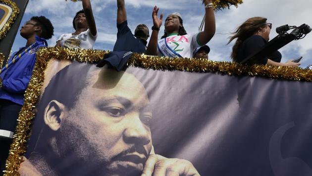 People aboard a float from Florida International University wave to crowds during a parade honouring the Rev. Martin Luther King Jr. (Wilfredo Lee/AP) People aboard a float from Florida International University wave to crowds during a parade honouring the Rev. Martin Luther King Jr. (Wilfredo Lee/AP)