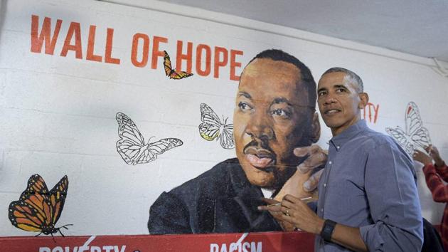 President Barack Obama helps paint a mural of Martin Luther King Jr. in Washington on Monday.(AP) President Barack Obama helps paint a mural of Martin Luther King Jr. in Washington on Monday.(AP)