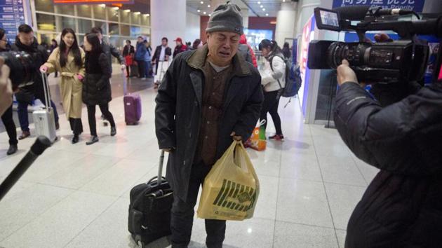 Wen Wanchang, whose son was on board the missing Malaysia Airlines Flight 370, reacts to journalists filming him as he arrives at the train station in Beijing, China, January 17, 2017. Some relatives of Flight 370's passengers expressed anger, disappointment and a resolve to press authorities to resume their efforts and find out exactly what happened. Others said they understood that the search — the most expensive of its kind in aviation history — had to come to an end. (AP)