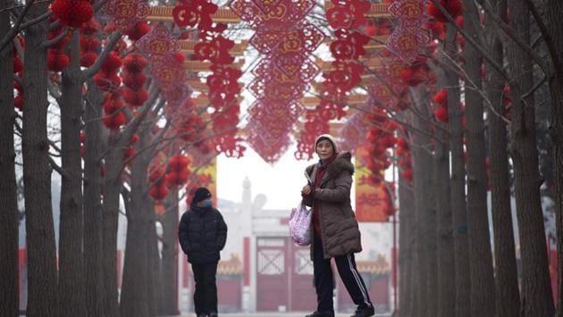 A woman visits a park in Beijing on Tuesday. Chinese New Year, known locally as the spring festival, falls on January 28 this year. (WANG Zhao / AFP)