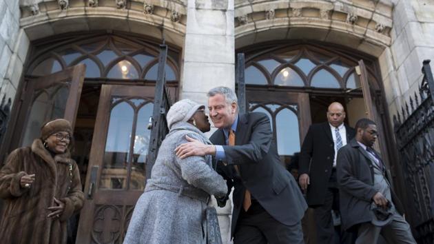New York Mayor Bill de Blasio greets Rivania Scott as he departs the Convent Avenue Baptist Church after delivering remarks for Martin Luther King Jr. Day in New York. (Karsten Moran/NYT) New York Mayor Bill de Blasio greets Rivania Scott as he departs the Convent Avenue Baptist Church after delivering remarks for Martin Luther King Jr. Day in New York. (Karsten Moran/NYT)