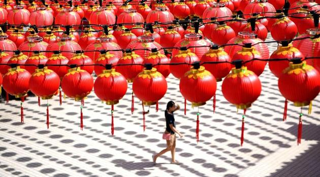 A woman walks under traditional Chinese lanterns decorated at the Thean Hou temple in Kuala Lumpur on Tuesday. (MANAN VATSYAYANA / AFP)