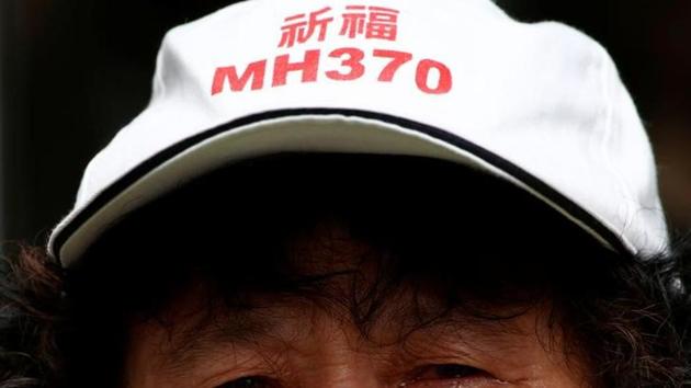 A family member of a passenger aboard Malaysia Airlines flight MH370, which went missing in 2014, reacts during a protest outside the Chinese foreign ministry in Beijing on July 29, 2016. The hat reads "Pray for MH370". (Reuters) A family member of a passenger aboard Malaysia Airlines flight MH370, which went missing in 2014, reacts during a protest outside the Chinese foreign ministry in Beijing on July 29, 2016. The hat reads "Pray for MH370". (Reuters)