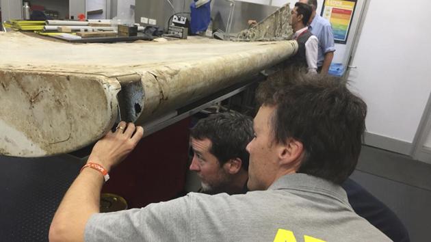 In this July 20, 2016 file photo released by the Australian Transport Safety Bureau (ATSB), investigators examine a piece of aircraft debris at their laboratory in Canberra. (AP)