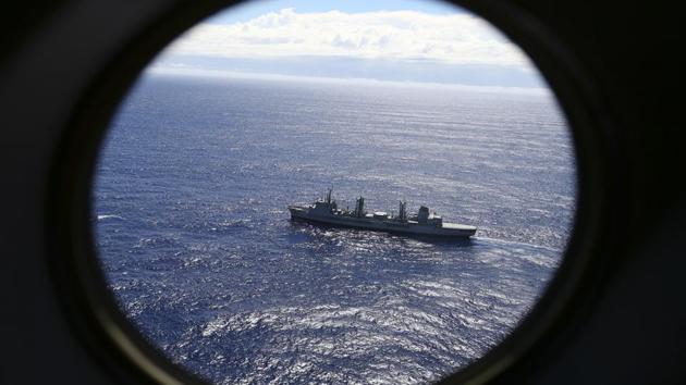 In this March 31, 2014 file photo, HMAS Success scans the southern Indian Ocean, near the coast of Western Australia, as a Royal New Zealand Air Force P3 Orion flies over, while searching for Flight MH370. (AP)