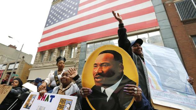 Rolandra Fields (right) waves from the back of a flatbed trailer during the annual Martin Luther King Day march. (Mike Brown/Getty Images/AFP) Rolandra Fields (right) waves from the back of a flatbed trailer during the annual Martin Luther King Day march. (Mike Brown/Getty Images/AFP)
