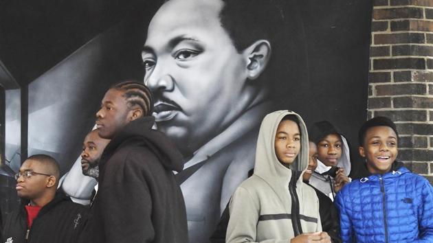 Students and MLK Legacy March participants wait near a huge wall hanging of Dr. Martin Luther King Jr. before the start of the 8th annual MLK Legacy march in honour of the Martin Luther King Jr. holiday in Detroit. (Daniel Mears/Detroit News via AP) Students and MLK Legacy March participants wait near a huge wall hanging of Dr. Martin Luther King Jr. before the start of the 8th annual MLK Legacy march in honour of the Martin Luther King Jr. holiday in Detroit. (Daniel Mears/Detroit News via AP)