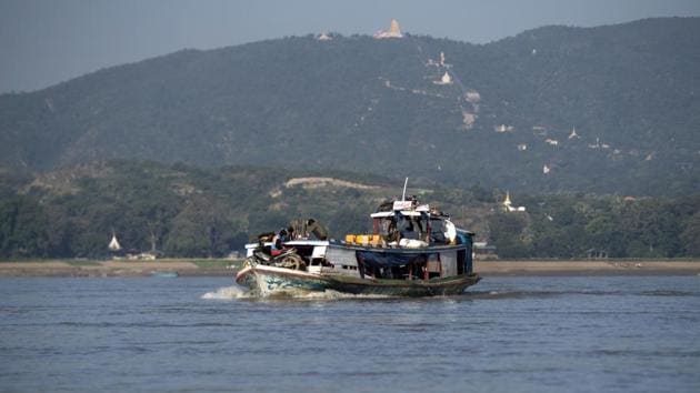 This photo taken on November 23, 2016 shows People travelling in the Irrawaddy river near Mandalay. Irrawaddy dolphins can be found in rivers, lakes and seas across southern Asia, from the northwest Bay of Bengal, in India, to the south of Indonesia. Fishermen say the greatest danger comes from rogue gangs who are wiping out river life in their quest for easy money. (Ye Aung Thu/AFP)